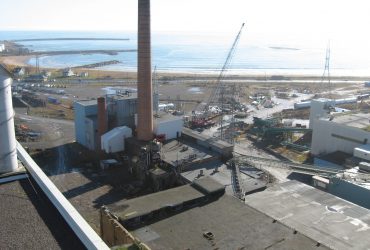 Aerial view showing a stack and other buildings to be demolished