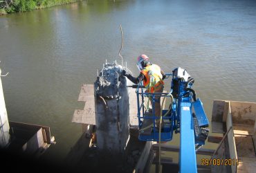 One Démex employee flame cutting components off a skyjack lift