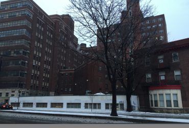 Street view showing the hospital before demolition work begins