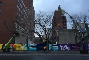 Distant view showing work taking place on two different buildings simultaneously