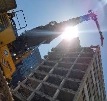 Impressive view of a long reach excavator at work