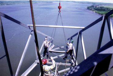 Three Démex employees attaching elements of the structure to be taken down