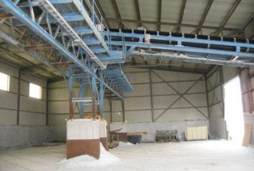 Interior view of a light gage steel structure building showing an elevated conveyor