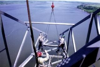 Aerial view of workers dismantling a pylon in the middle of the St Lawrence river