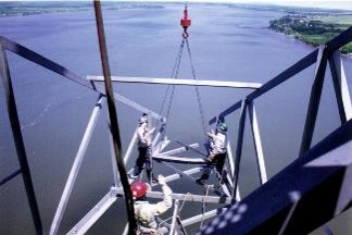 Aerial view of workers dismantling a pylon in the middle of the St Lawrence river