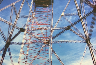 Bottom to top view of the pylon showing the scaffolding used and a crane at the top