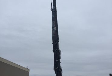 View of the PC 800 excavator with the long reach boom fully extended vertically