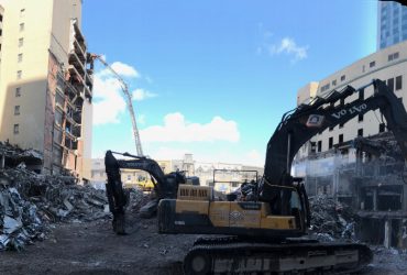 Use of excavators to demolish sections located very close to a brand new building