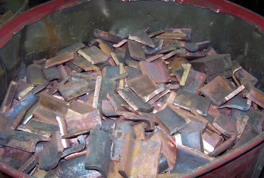 Cut up copper plates in a drum at Centrem recycling center in Alma