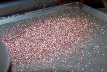 Copper granules on a vibrating screen