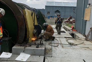 Two Démex employees cutting up steel elements