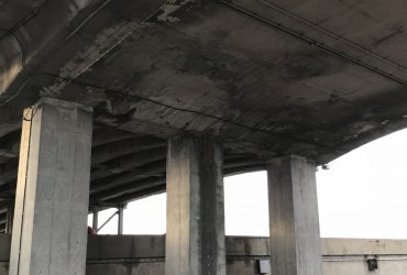 Démex pick-up truck underneath a structure to be demolished