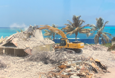 Excavator demolishing a concrete structure