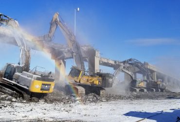 Several excavators demolishing an elevated ramp of the Turcot interchange