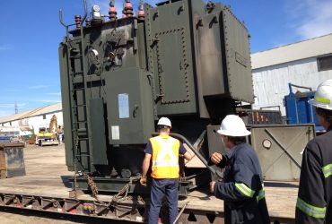 Centrem employees receiving a transformer loaded on a low deck trailer, to be recycled within at Centrem in Alma