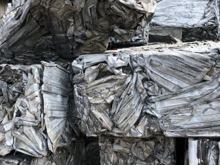 Bale of steel building siding after baling – Bushelling #1, piled outside Centrem recycling enter in Alma