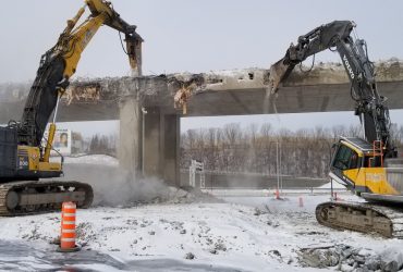 Two excavators crushing concrete directly on a ramp near Angrignon boulevard during winter