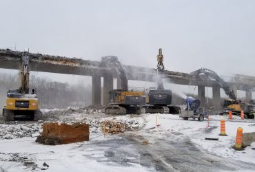 Several excavators crushing concrete directly on a ramp near Angrignon boulevard during winter