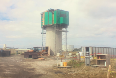 One of the two stacks almost completely demolished, showing a temporary structure built specifically to protect employees and the environment