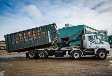 Roll-off truck picking up a container at Centrem recycling center in Alma